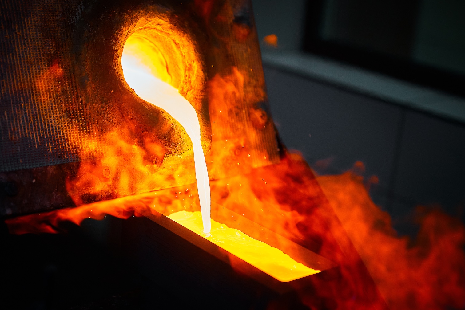 Molten gold being poured into a mold during the production of fine gold bullion.